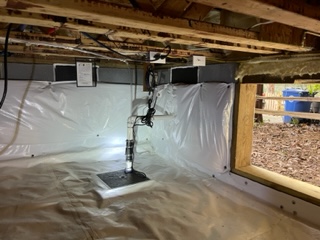 Finished encapsulation with a dehumidifier and sump pump.